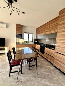 a kitchen with a table and chairs in a room at Skyline Gozo Penthouse with Jacuzzi in Xagħra +18 photos