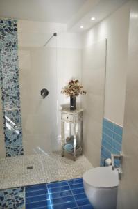 a bathroom with a toilet and a glass shower at Casa Gaia, Piombino in Piombino +39 photos