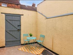 two chairs and a table next to a door at Seymour Rest in Loftus