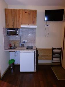 a kitchen with a counter and a sink and a microwave at Résidence Molière Hôtel Paris Montrouge in Montrouge