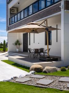 a patio with a table and an umbrella at 巷往 villa in Dongshan