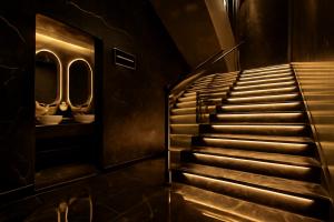 Una escalera en un edificio con dos lavabos y dos espejos. en Daif Inn Serviced Apartments - Al Naseem, en Riad 49 fotos más