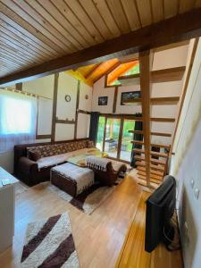 a large living room with a couch and a staircase at UNA Dream in Ivišovo Greblje