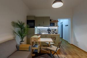 a living room with a table and a kitchen at Studio 44 in Belgrade