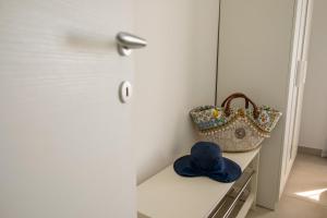 a table with a hat and a purse on it at Shalacory in Riposto