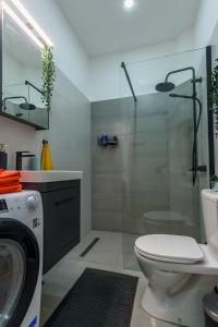 a bathroom with a toilet and a glass shower at Studio 44 in Belgrade +18 photos
