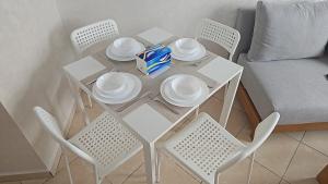 a white table with plates and chairs and a couch at El Rincón Bonito in Tetouan