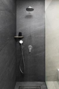 a bathroom with a shower with a shower head at Meteoron Suites in Kalabaka +84 photos
