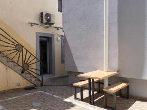 two benches sitting next to a building with a staircase at Apartment Možina in Koper