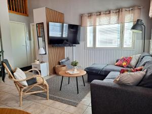 a living room with a couch and a table at Metsätuuli 4 in Kalajoki