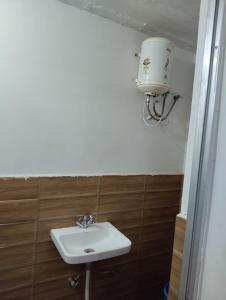 a bathroom with a sink and a water tank at Balaji guest house in Jāmb