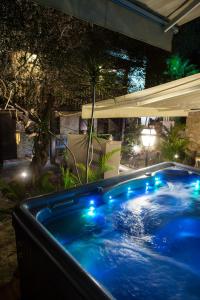 a pool with a pool table and a pool umbrella at Carmel Pearl in Haifa