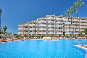 a large hotel with a large swimming pool in front of it at Grupotel Port D´Alcudia in Port d'Alcudia