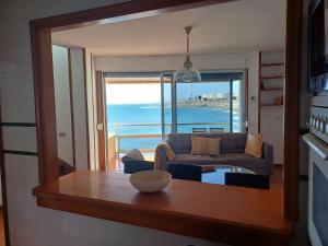 a living room with a couch and a view of the ocean at Sobre el Mar by CanariApartment, Oceanfront House with 3 Balconies in Salinetas in Telde