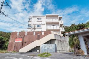 a building with a staircase in front of it at unito villa OKINAWA Koza in Okinawa City