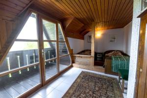 a bedroom with a bed and a large window at Vineyard cottage Rustika in Novo Mesto