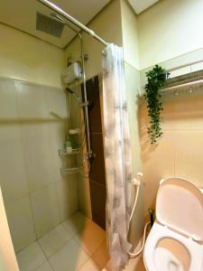 a bathroom with a toilet and a shower at Chateau Staycation in Manila