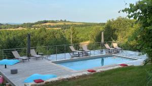a swimming pool with chairs and a deck at Gîte La Blanchie Haute in Martel +49 photos