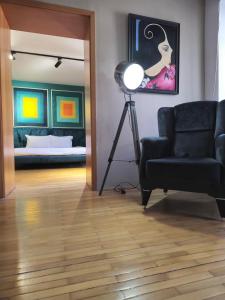 a living room with a couch and a lamp at Main square - Palace La Grande 150 m2 in Skopje