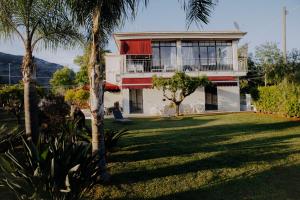 a house with palm trees in front of it at Le Vie di Feronia in Terracina