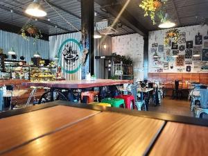 a bar with tables and chairs in a restaurant at Marine Apartments in Honiara