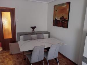 a dining room with a white table and chairs at Chillout La Rioja in Haro