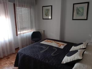 a bedroom with a bed and a chair and a window at Chillout La Rioja in Haro +15 photos
