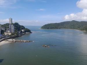 an aerial view of a body of water with a beach at Kitão PÉ na Areia in São Vicente +8 photos