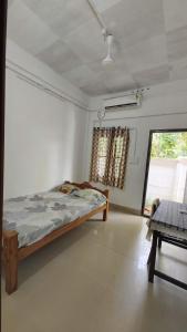 a bedroom with a bed in a room with a window at IslandStay-a riverside property in Kollam +55 photos