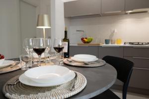 a table with plates and wine glasses on it at Shalacory in Riposto