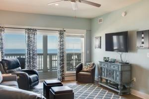 a living room with a view of the ocean at Star of the Sea in Kill Devil Hills