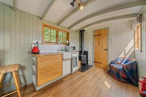 a kitchen with a sink and a counter top at Corry Lodge Estate - Sheperds Huts or Container Stays with Sea View in Broadford +36 photos