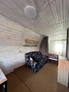 a living room with a couch in a room at Дача Фонтанка in Fontanka