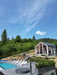 a house on a hill with a swimming pool at Rest Hub in Slavske