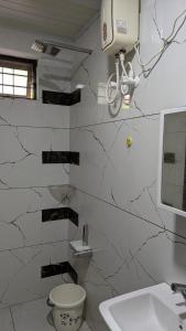 a bathroom with a toilet and a sink at village stay Chittur Thathamangalam in Tattamangalam