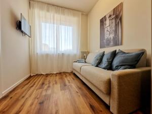 a living room with a couch and a window at Al Castello in Vicenza