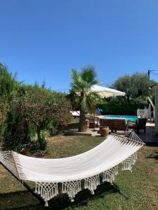a white hammock in a yard next to a pool at Villa ANOLPA in Vence