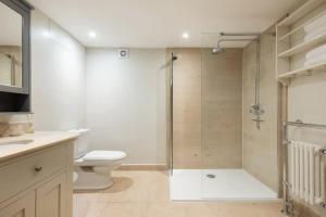 a bathroom with a shower and a toilet and a sink at The Midsummer Common - Modern & Spacious 2BDR House with Garden in Cambridge +21 photos