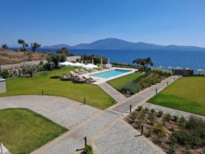 a resort with a swimming pool and the ocean at SeaSide Village in Politiká