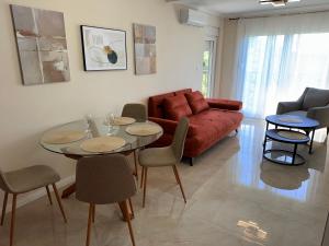a living room with a couch and a table and chairs at Sunset Serenade Apartment 