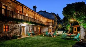 a courtyard of a building with a table and chairs at Luxurious Chateau Asa in Sežana in Sežana