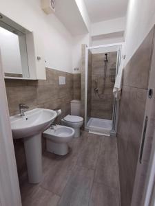 a bathroom with a sink and a toilet and a shower at Studio 23 in Partinico