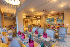 a dining room with a long table and chairs at Mastiff Select Mandavya Dharamkot, McLeodganj in Dharamshala