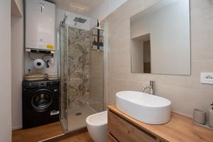 a bathroom with a sink and a washing machine at La casa del Viaggiatore in Savona +27 photos