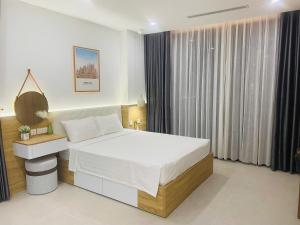 Ένα ή περισσότερα κρεβάτια σε δωμάτιο στο Scenia Bay Nha Trang view biển cực xịn