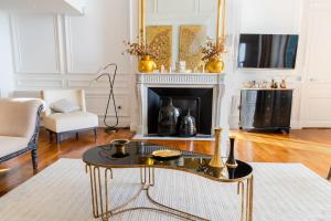 a living room with a table and a fireplace at Luxury Duplex 2BR Panoramic Sea View Monaco in Beausoleil +16 photos