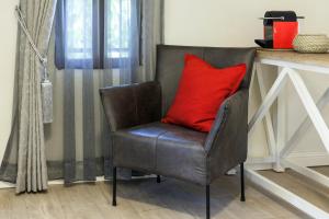 a living room with a red couch and a red chair at Carmel Pearl in Haifa