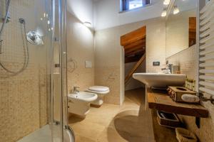 a bathroom with a sink and a toilet and a shower at PETIT CHALET ANNA - Rifugio in mezzo alle montagne in La Thuile +30 photos