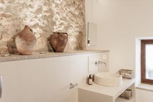 a bathroom with a sink and a vase on a shelf at The Old Cottage - Cas Julians Sencelles Ruberts in Sencelles +25 photos