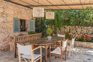 a wooden table and chairs on a patio at The Old Cottage - Cas Julians Sencelles Ruberts in Sencelles